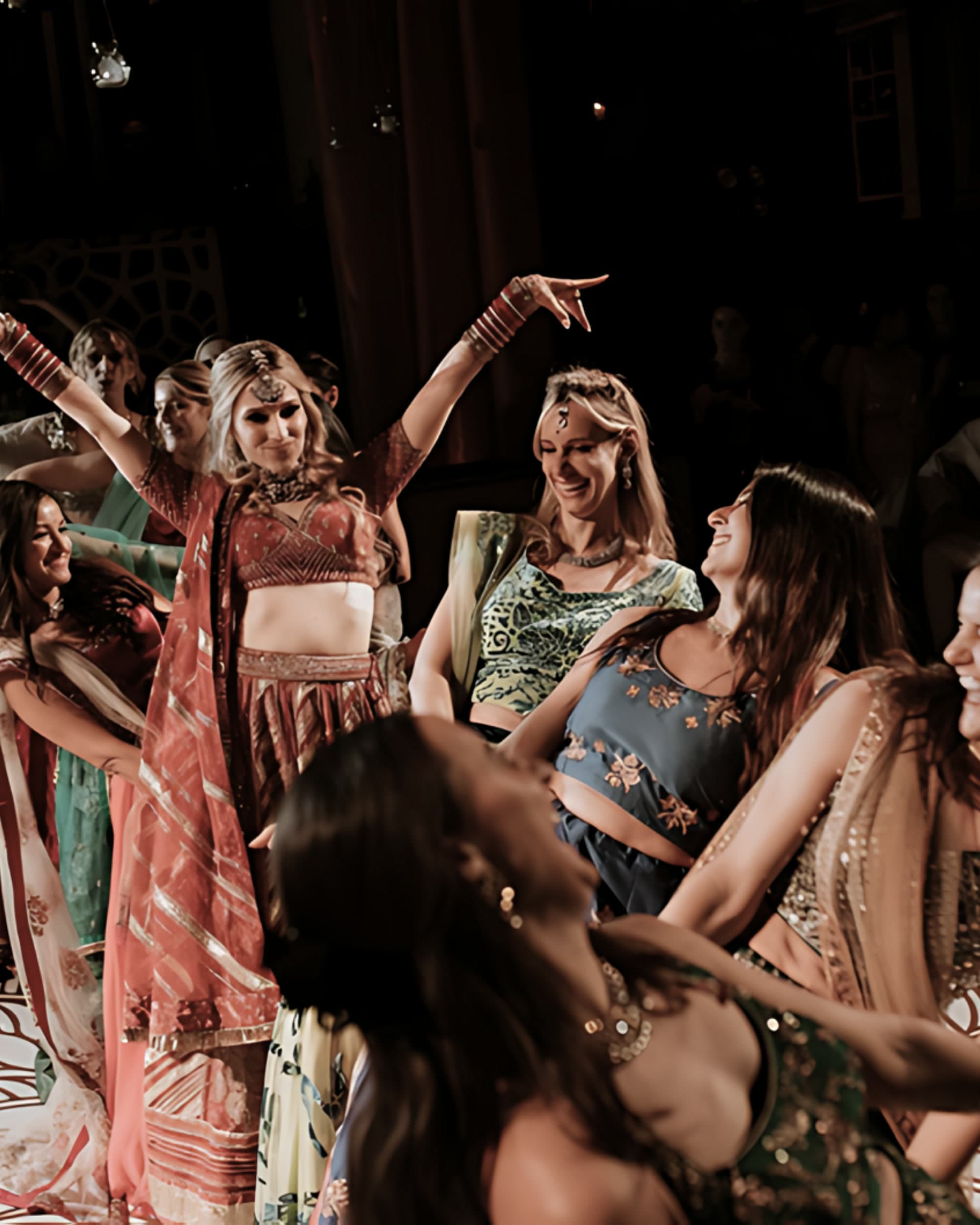 Guests dancing in lehengas at an Indian wedding with vbmusic DJs