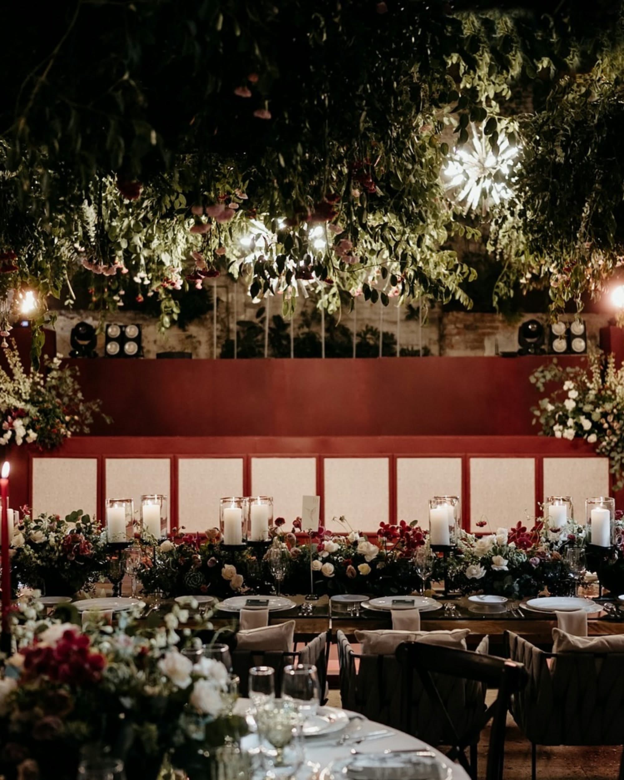 Reception tablescape under a hanging floral canopy