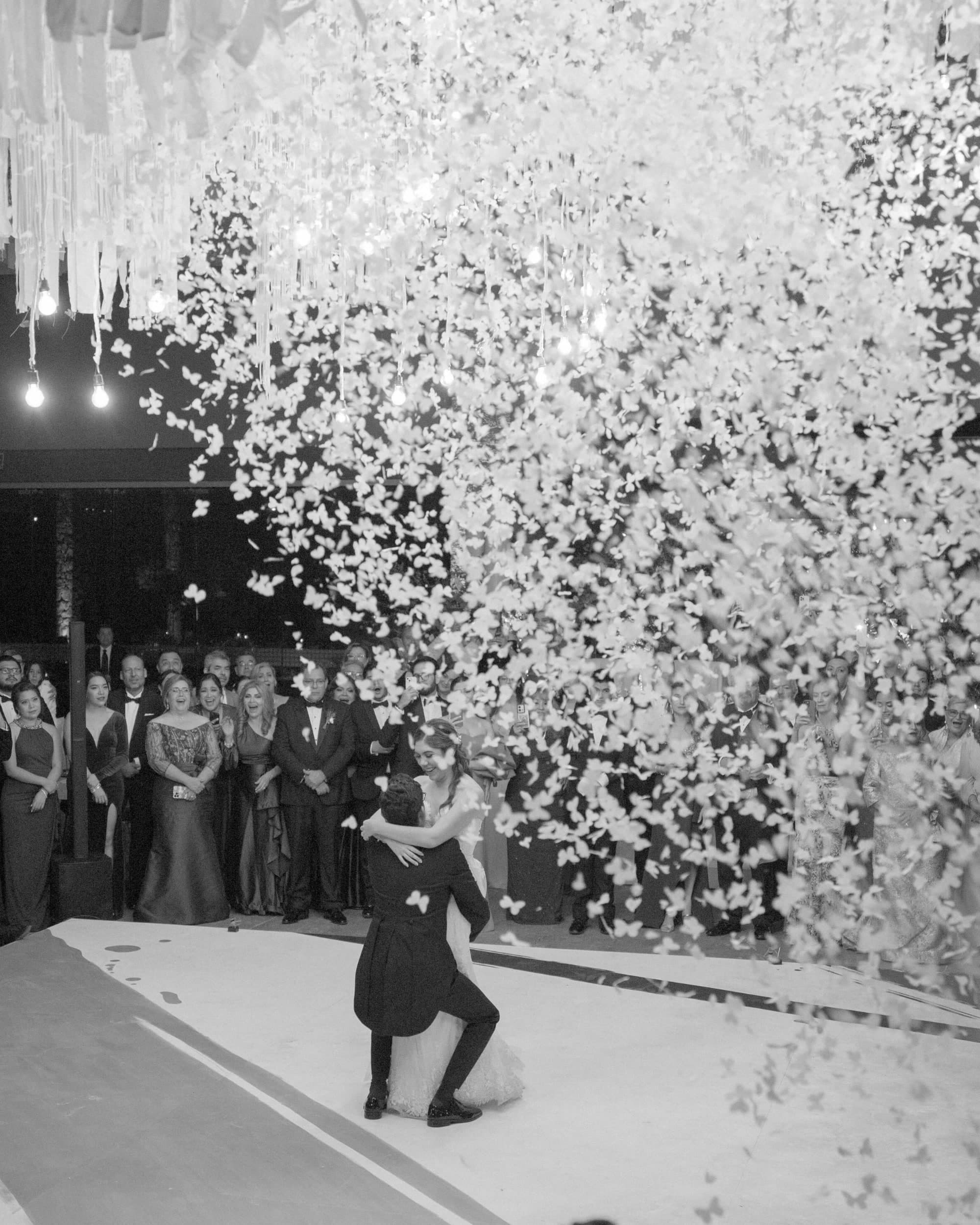First dance under a confetti drop at a wedding produced by vbmusic